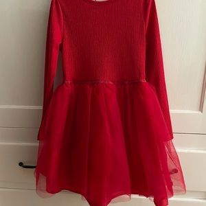 Red dress with tutu style skirt. Dress is all one piece. With cute waist detail
